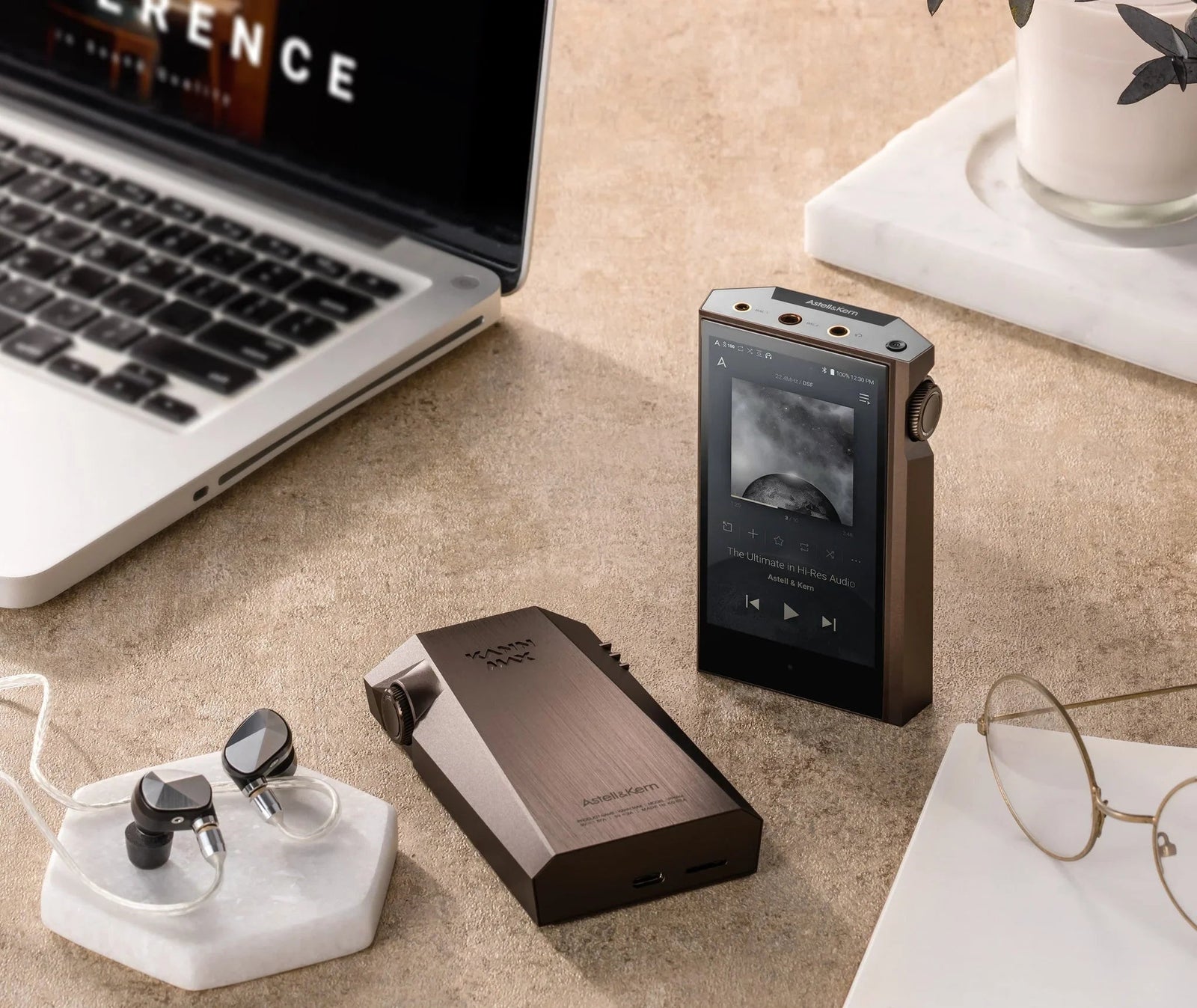 Astell&Kern KANN MAX hi-res digital audio player, earphones, and laptop on a desk at The Source AV