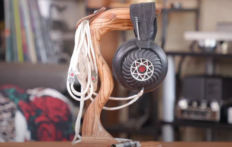 Spirit Torino Pulsar headphones on wooden stand with cable, high-end audio gear display at The Source AV