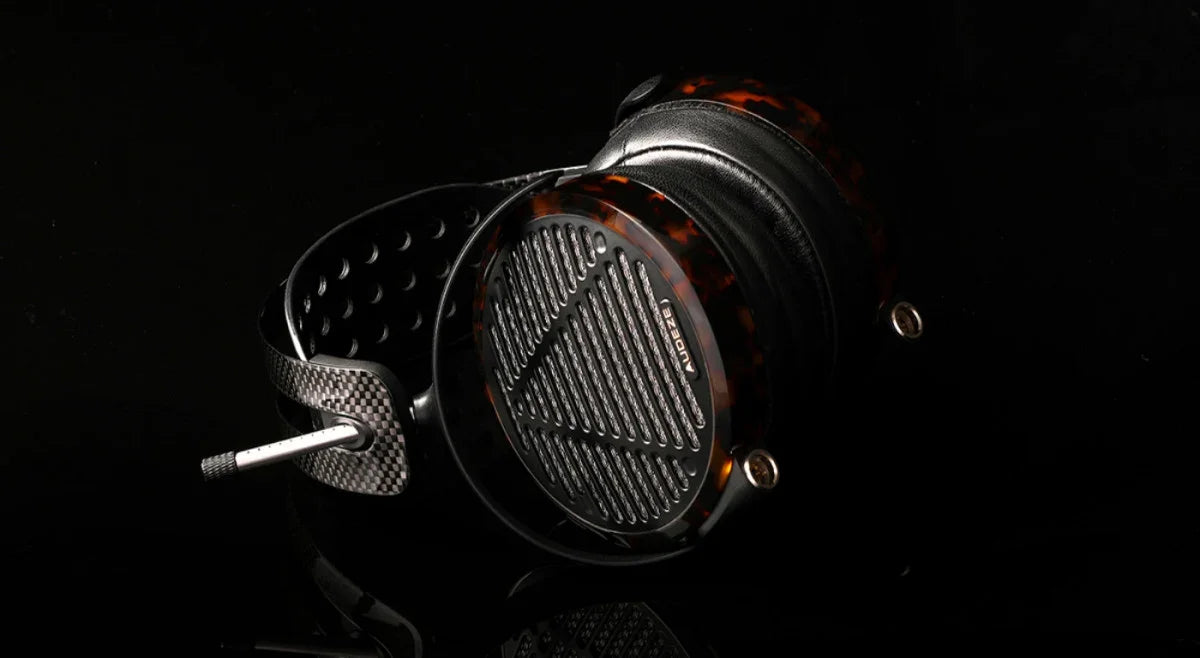 High-end Audeze headphones with tortoise shell accents and perforated headband on black background