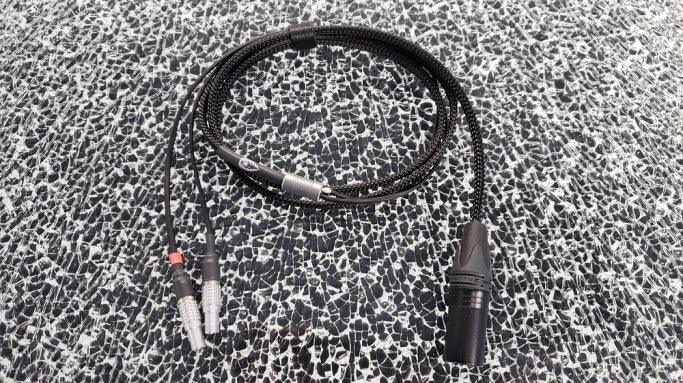 High-quality audio XLR to RCA cable with braided black sleeve on patterned surface, The Source AV