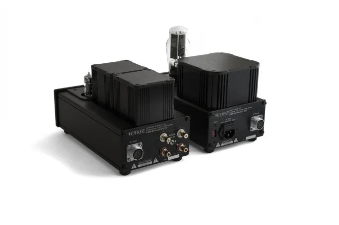 High-end black tube audio amplifiers with visible vacuum tubes and RCA jacks, on white background