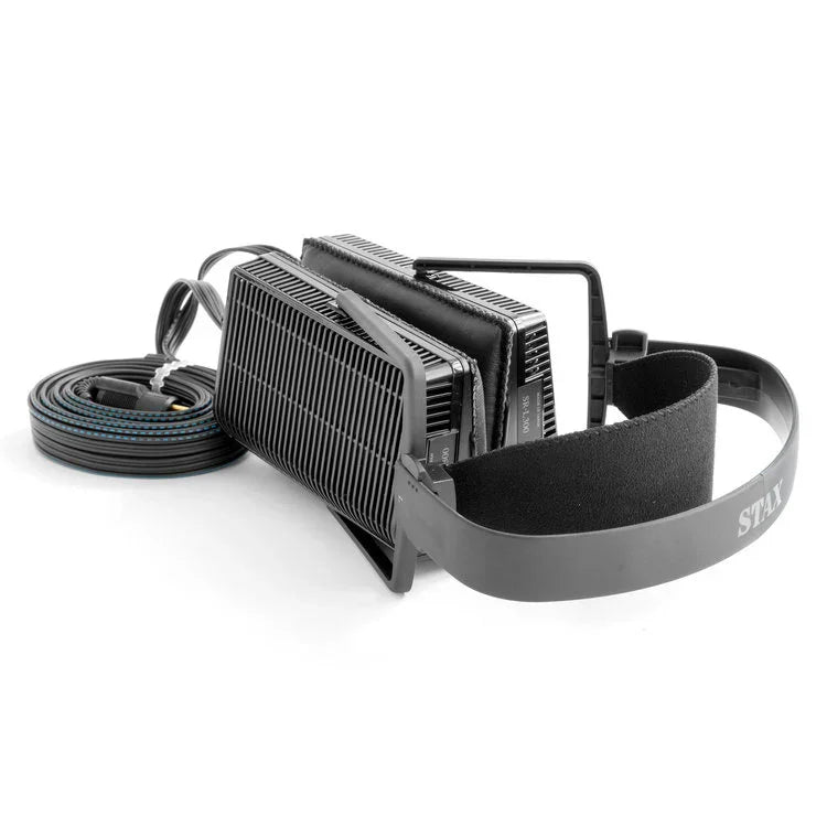 High-end open-back headphones with black grille design and coiled cable, The Source AV audio gear.