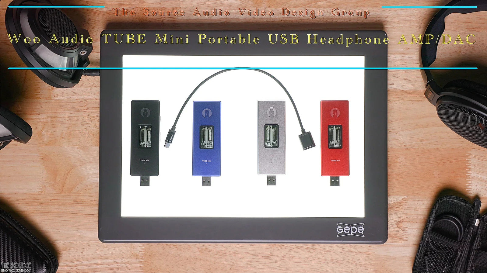 Woo Audio TUBE Mini portable USB headphone amp and DAC in four colors on a lit display with headphones, available at The Source AV.